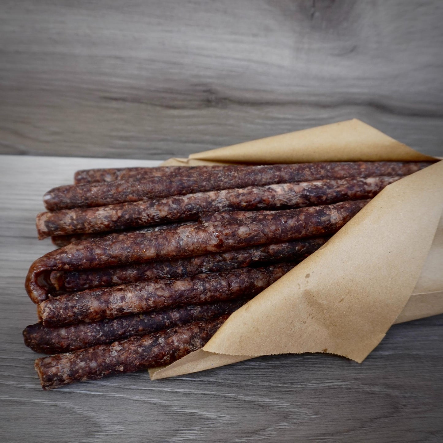 Close-up of dried meat sticks on a gray background