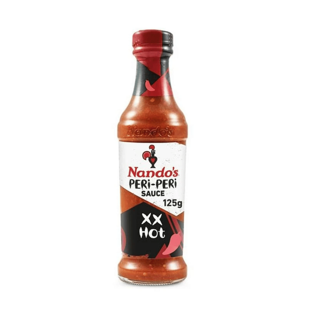A 125g bottle of Nando's Peri-Peri Sauce, XX Hot, featuring a white label with red and black graphics, set against a plain white background.