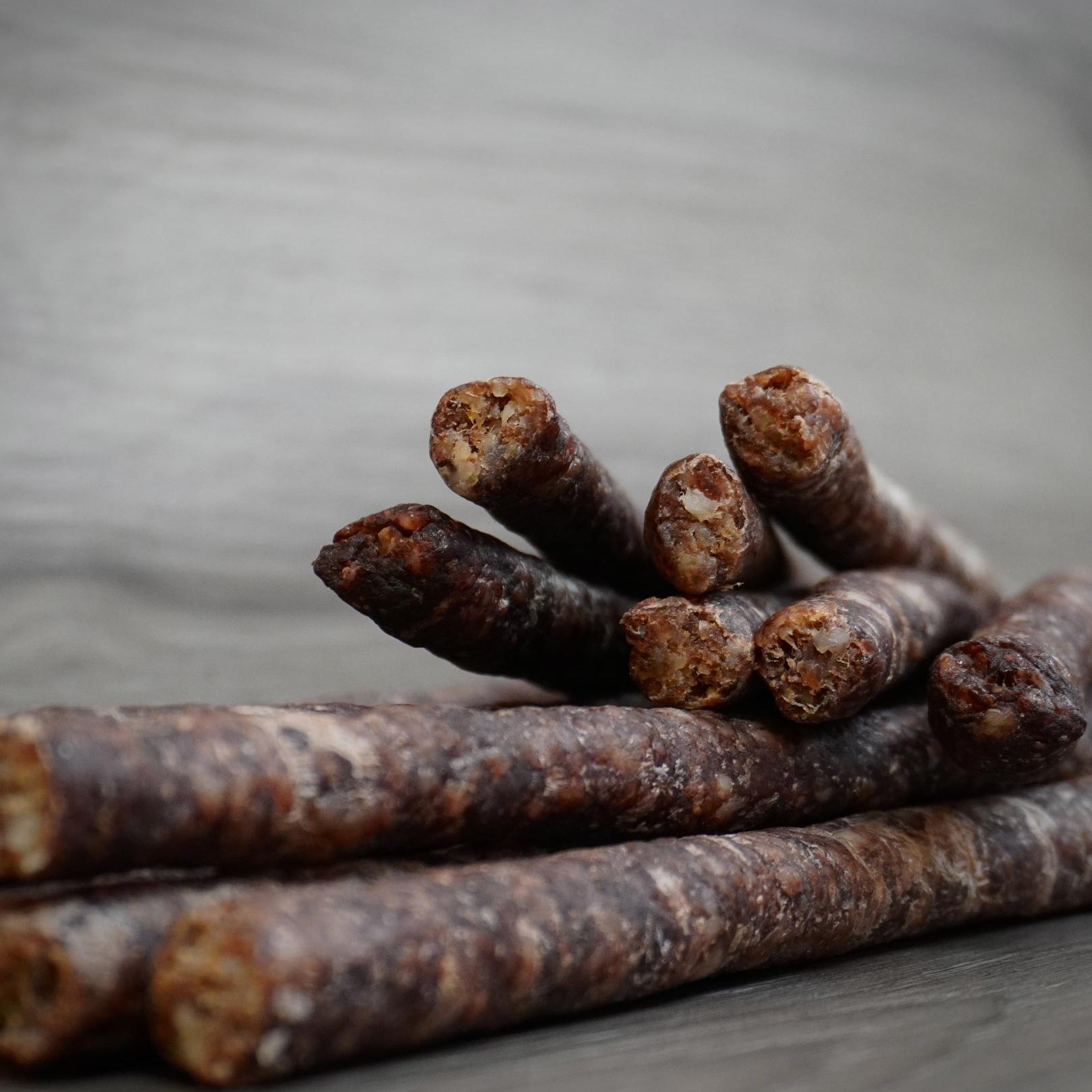 Close-up of dried meat sticks on a gray background