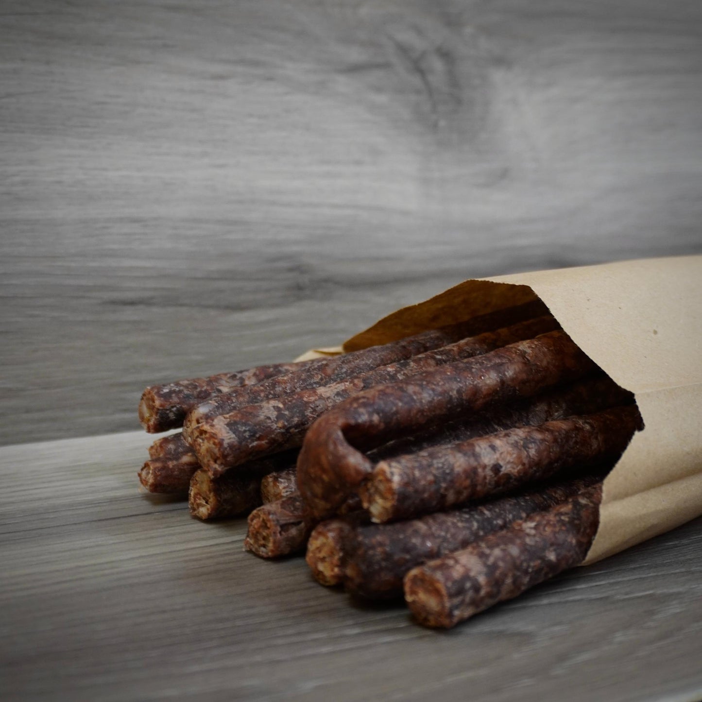Close-up of dried meat sticks on a gray background