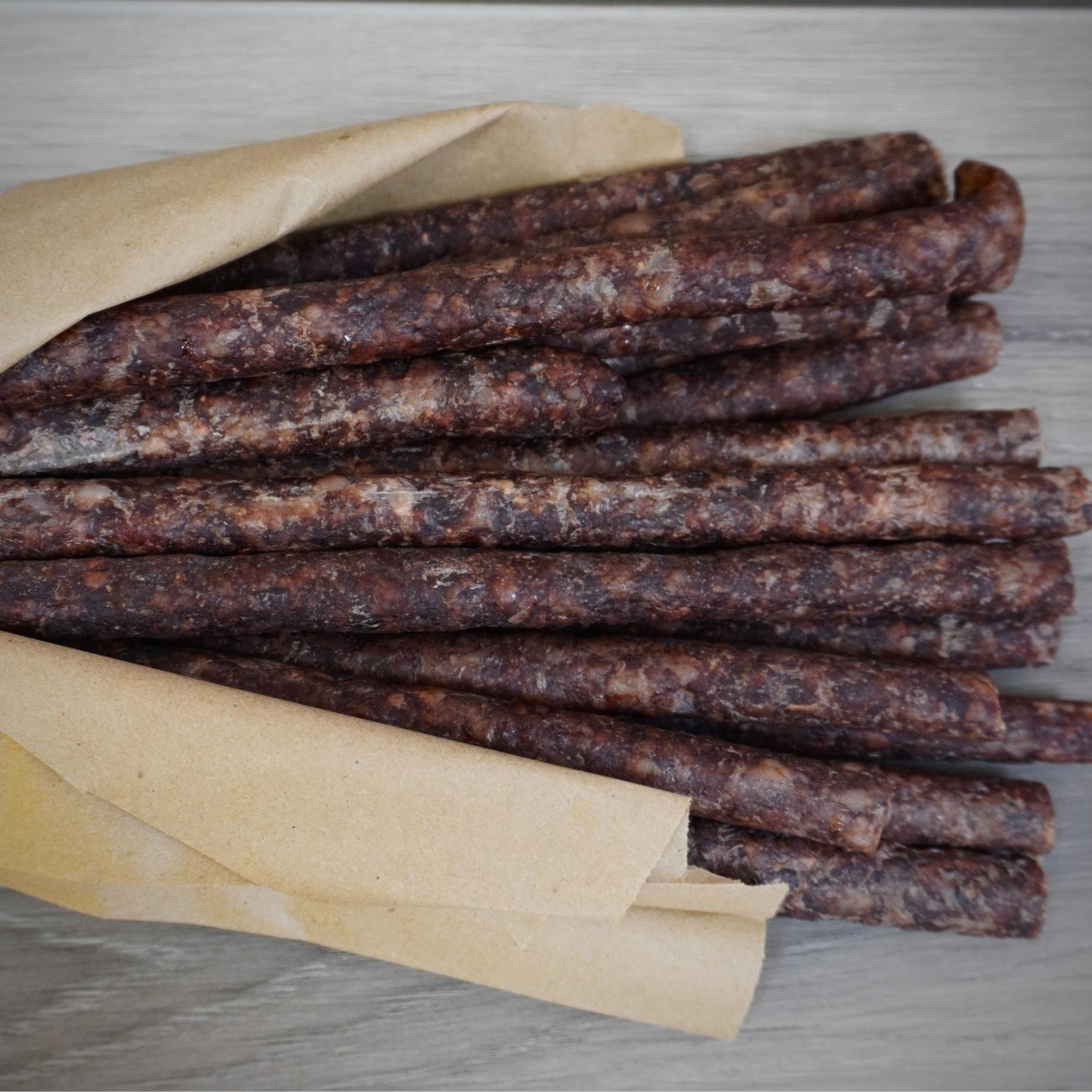 Close-up of dried meat sticks on a gray background