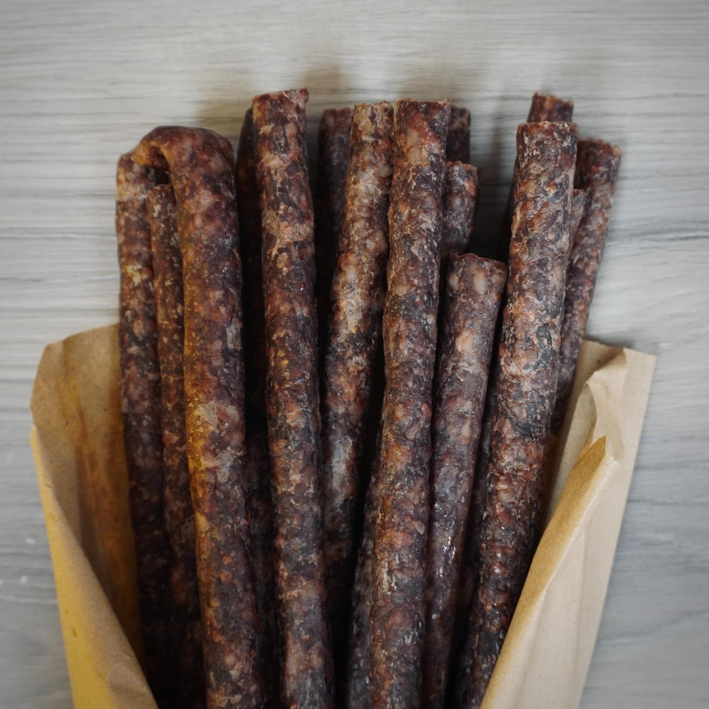 Close-up of dried meat sticks on a gray background