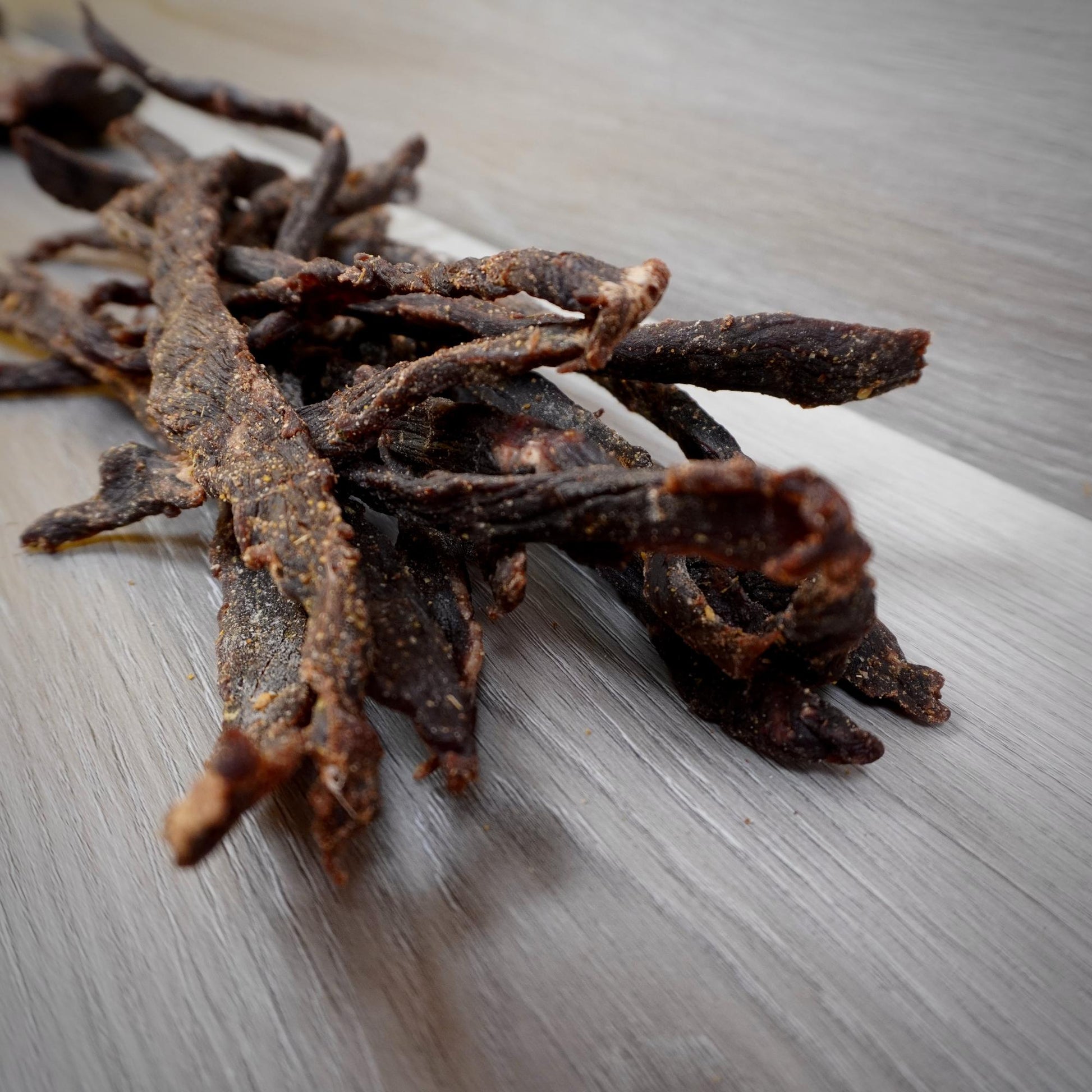Dried beef jerky on a metallic surface